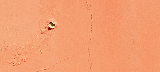 Texture of cracked wall. Old terracotta painted background. Banner with cracks, scrapes, peeling, holes