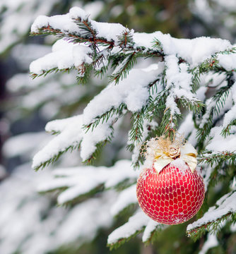the Christmas fir-tree in snow is decorated with toys