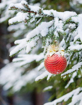 the Christmas fir-tree in snow is decorated with toys
