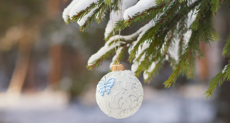 Christmas sphere on a snow-covered fir-tree