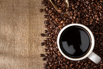 Coffee cup and coffee beans with wicker copy space