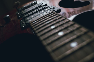 Fototapeta na wymiar red electric guitar strings isolated on black background, closeup