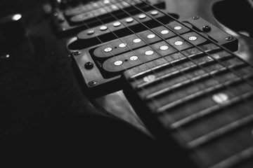 red electric guitar strings isolated on black background, closeup, black and white