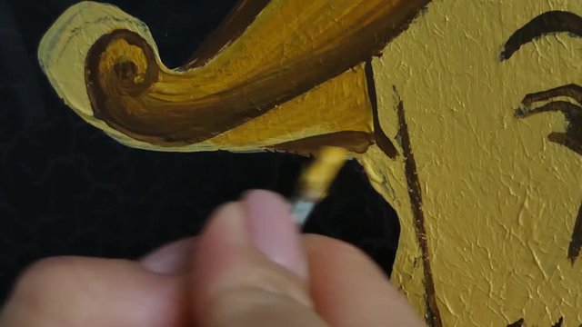 painter decorator draws face of Chinese man, macro shooting