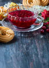 Christmas hot cranberry tea, cookies and orange slices, on dark background.