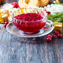 Christmas hot cranberry tea, cookies and orange slices, on dark background.