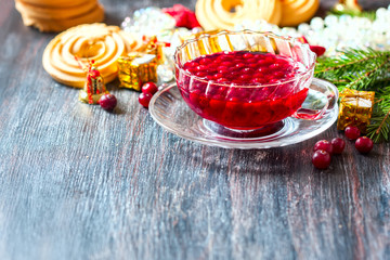 Christmas hot cranberry tea, cookies and orange slices, on dark background.