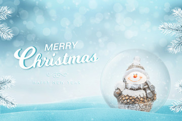 Christmas greeting card with text. Glass magic ball with snow and snowman beside.