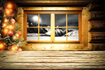 Wooden table and winter window and christmas tree 