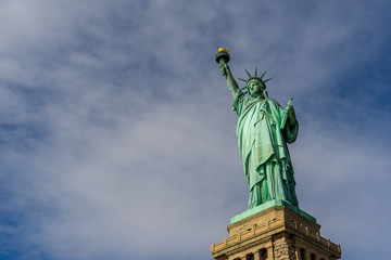 The Statue of Liberty at Liberty island and cloud blue sky background with copy spaces, Landmarks of New York City, USA , Close up view © Thongchai S.