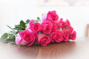 Pink Roses on a Wooden surface. Rose blooms.