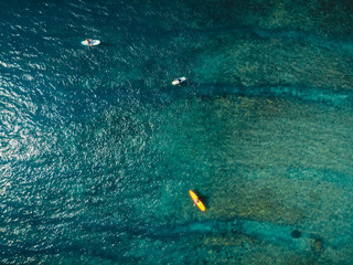 Aerial view of surfer and blue ocean water. Surfing in ocean