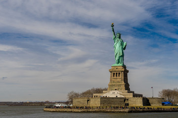 Front view of The Statue of Liberty on Liberty island with cloud blue sky background, Landmarks of New York City, USA © Thongchai S.