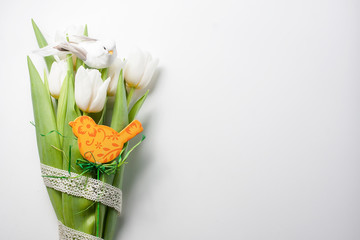 Easter arrangement  of a white tulips and wooden bird