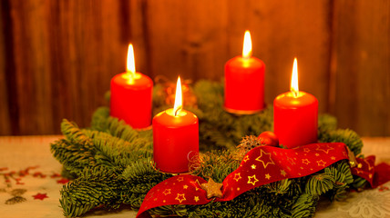 Weihnachten Adventskranz mit 4 brennenden Kerzen auf altem Holz