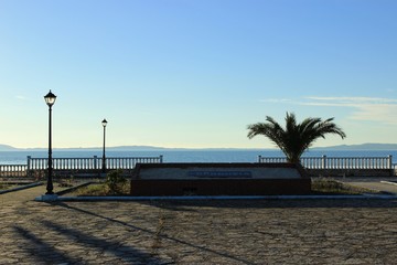 Αmbracian gulf behind the concrete retro fence made of cement from the square of Koronisia village...