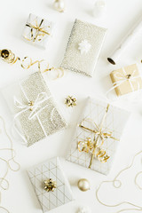 Christmas, New Year holiday composition with golden gift boxes, decorations on white background. Flat lay, top view of gifts packaging.