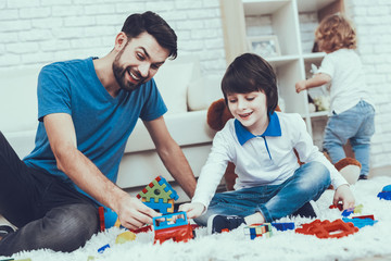Father and Sons is Playing with Toys