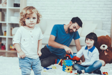 Naklejka premium Father and Sons is Playing with Toys