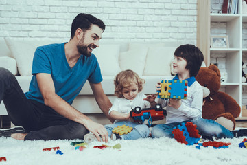 Father and Sons is Playing with Toys