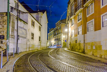 streetcar rails in the old part of Lisbon by night
