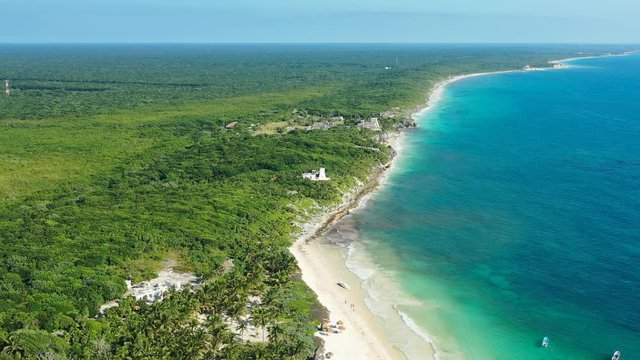 Aerial view of ancient Mayan city of Tulum, white sand beach and turquoise crystal clear waters of Caribbean Sea - landscape panorama of Yucatan Peninsula from above, Mexico, Central America, 4k UHD