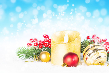 Christmas background. Red and golden decorations in snow.