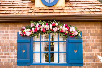 Blue colored door decorated with rose flowers