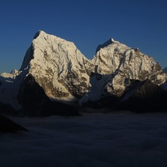 now covered mountains Cholatse and Taboche Peak just before sunset. View from Gokyo Ri, Nepal.