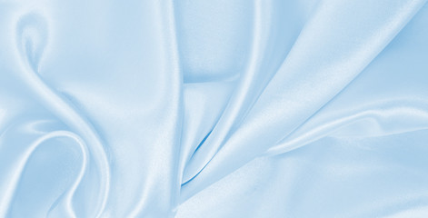 Smooth elegant blue silk or satin luxury cloth texture as abstract background. Luxurious background...