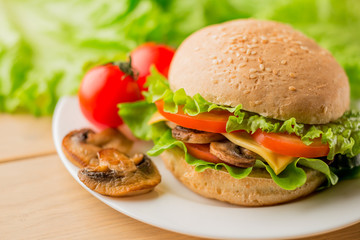 Vegetarian burger with fresh salad on the plate, close up
