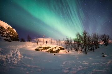 Landscape of snowy mountain with aurora borealis explosion