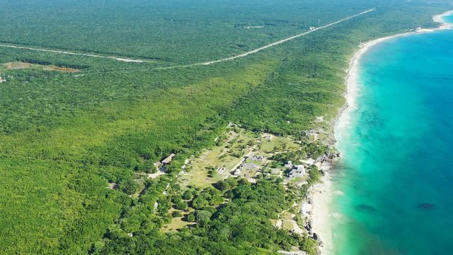 Aerial view of ancient Mayan city of Tulum, white sand beach and turquoise crystal clear waters of Caribbean Sea - landscape panorama of Yucatan Peninsula from above, Mexico, Central America, 4k UHD