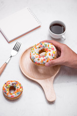 Coffee with tasty donuts for breakfast on table.