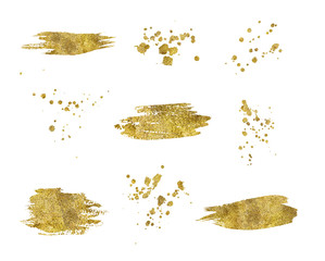 Collection of golden paint strokes splatters isolated
