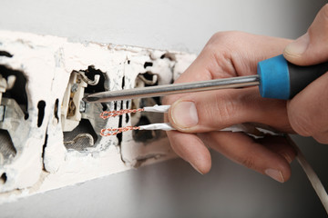 Violation of electrical safety rules, damaged socket in the wall.