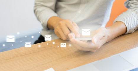 close up bsinessman holding smartphone and checking email online on web with virtual interface...