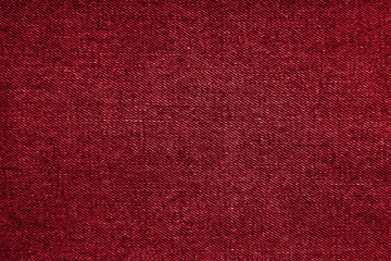 Red tone jeans denim fabric texture abstract background. Christmas background with copy space. Textile cotton casual wear