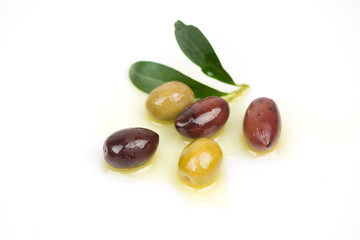 Different colors olives in a white background.