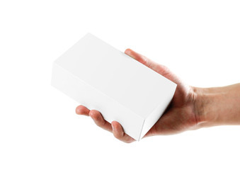 Hand holding white box. Close up. Isolated on white background.