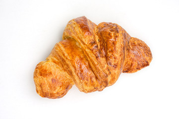 Fresh baked croissant on white background.