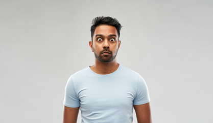 emotion, expression and people concept - shocked or scared man in t-shirt over grey background - obrazy, fototapety, plakaty