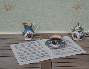 English teacup with saucer, sugar bowl and cream jug on a sheet of music