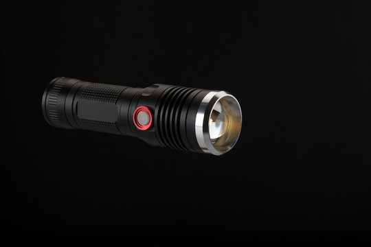 Tactical flashlight on a black background