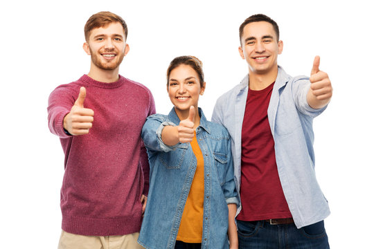 friendship and people concept - group of smiling friends showing thumbs up over white background