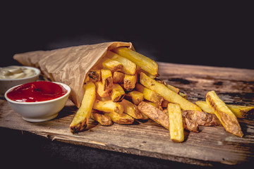 French fries Pommes Frites on Wood Dark - obrazy, fototapety, plakaty