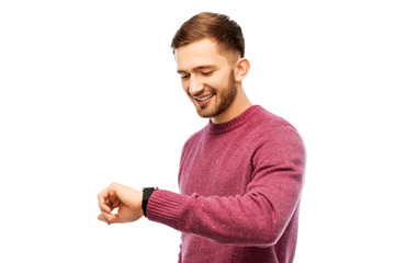 time, punctuality and people concept - smiling young man looking at wristwatch over white background