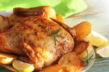 Whole roasted chicken with potatoes and lemon