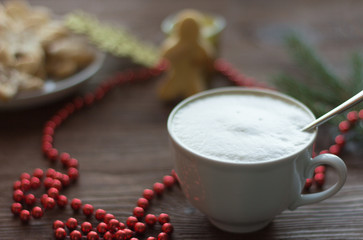 a Cup of coffee with a thick foam, Christmas cookies with sugar and cinnamon and Christmas decorations