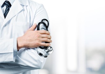 Young man doctor holding stethoscope